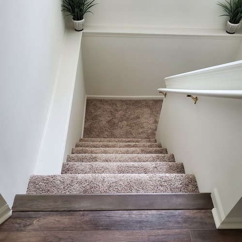 Stair flooring transition in Kentwood, MI from Absolute Floor Covering