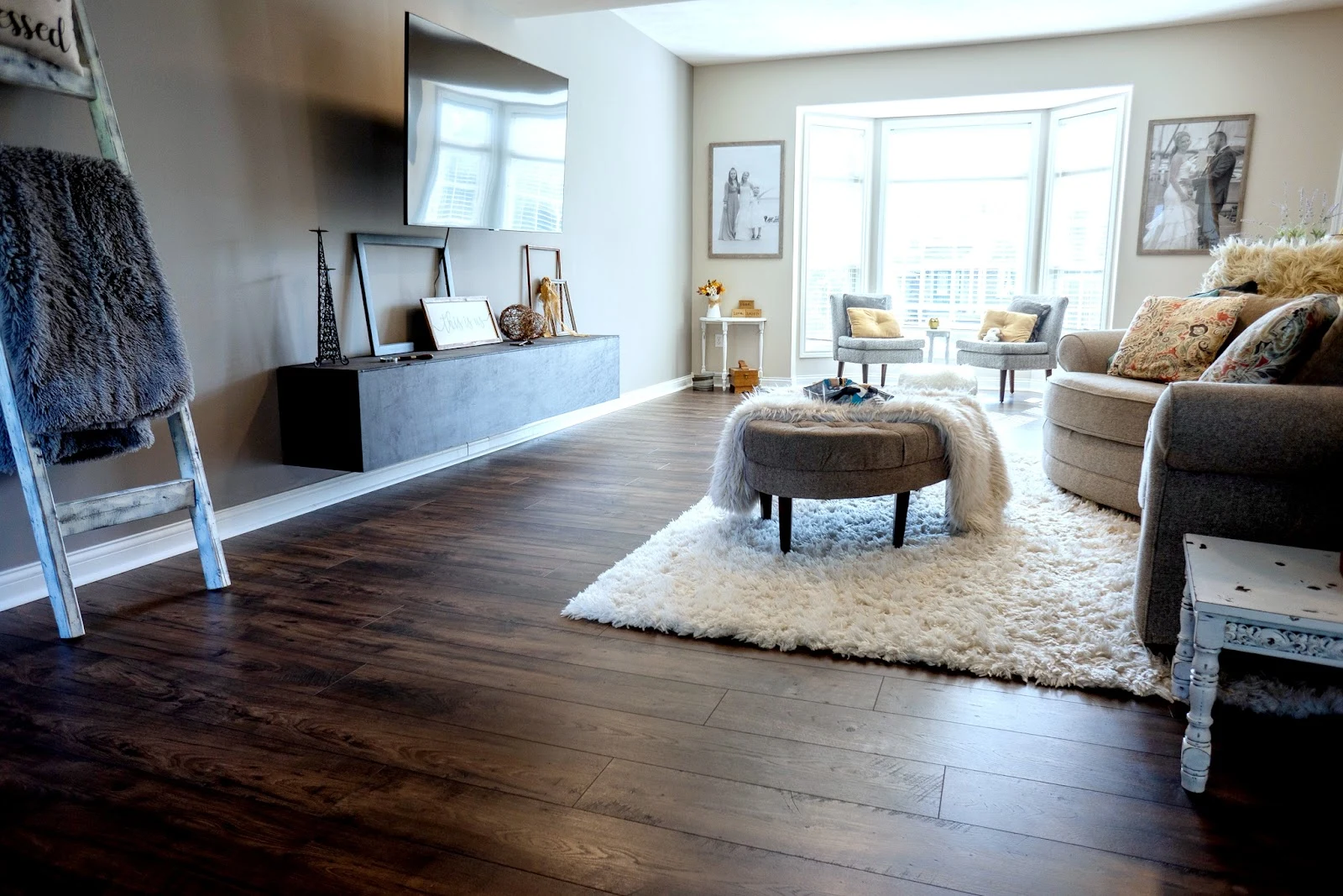 Bright vaulted-ceiling living room with rich hardwood flooring installed by Absolute Flooring and Design